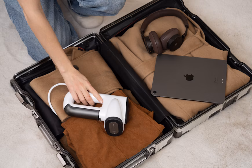  A well-organized flat lay of clothes and essentials for carry-on only travel.